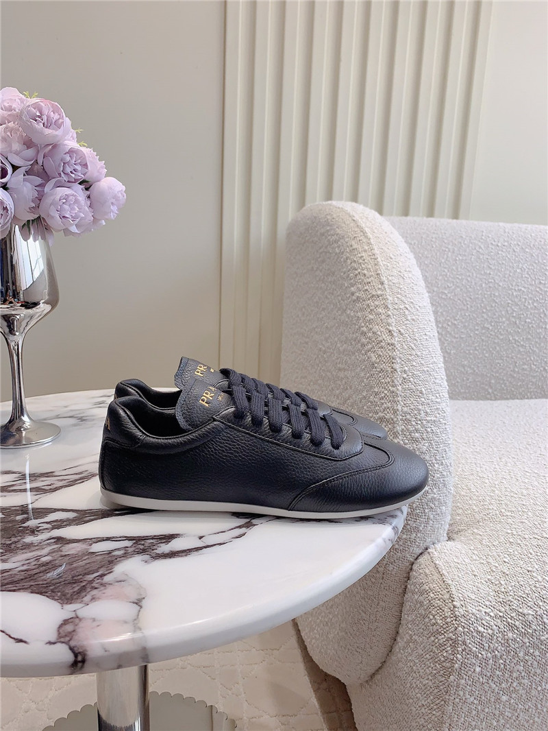 Pra*a triangle logo sneakers in black