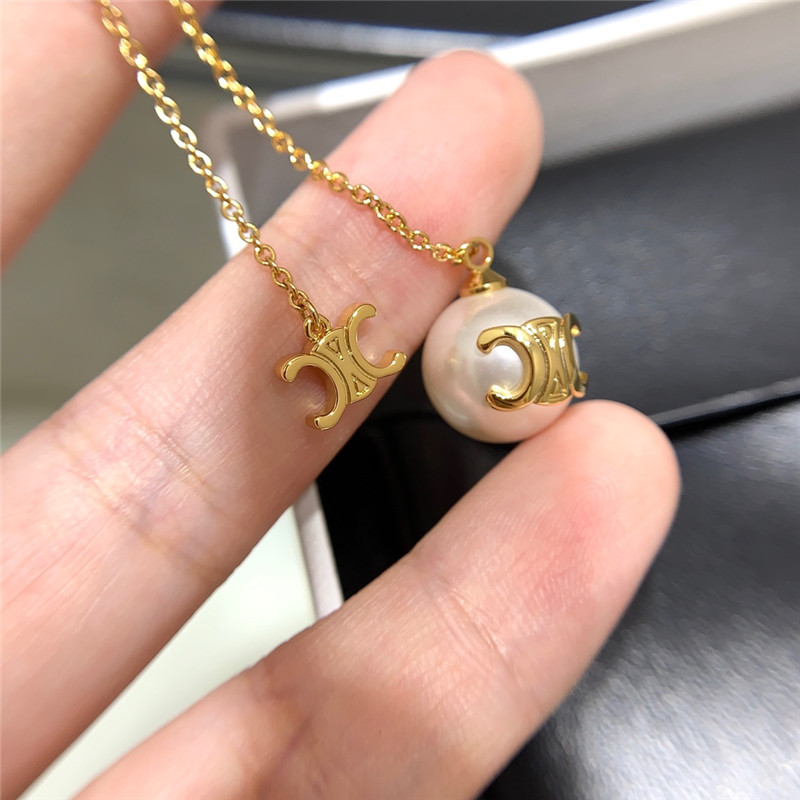 Ce1i*e double chain arc de triomphe hanging bead earrings