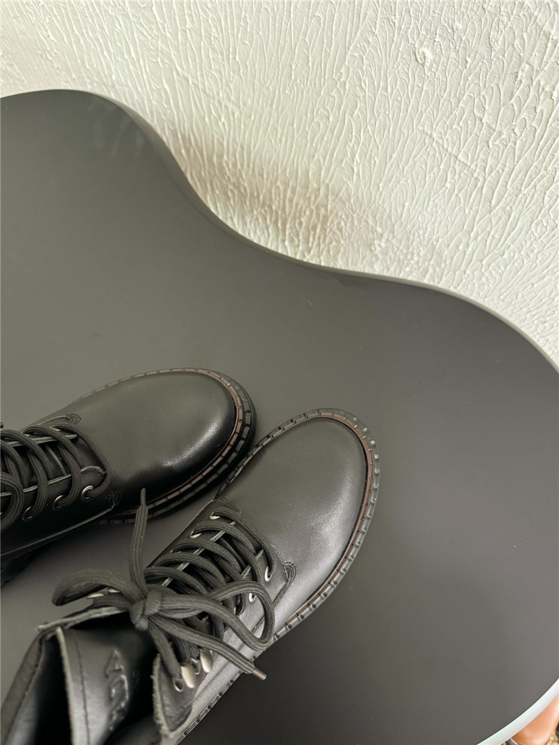 Pra*a black leather and re-nylon booties